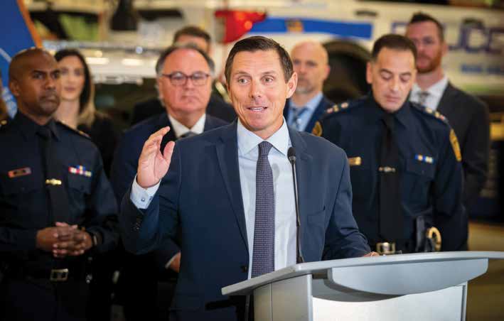 Mayor Patrick Brown speaking at a podium with Peel Regional Police officers behind him